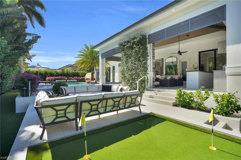 3110 Leeward Lane Naples, FL 34103 - Photo 46 of 50 a view of a patio with couches table and chairs with potted plants