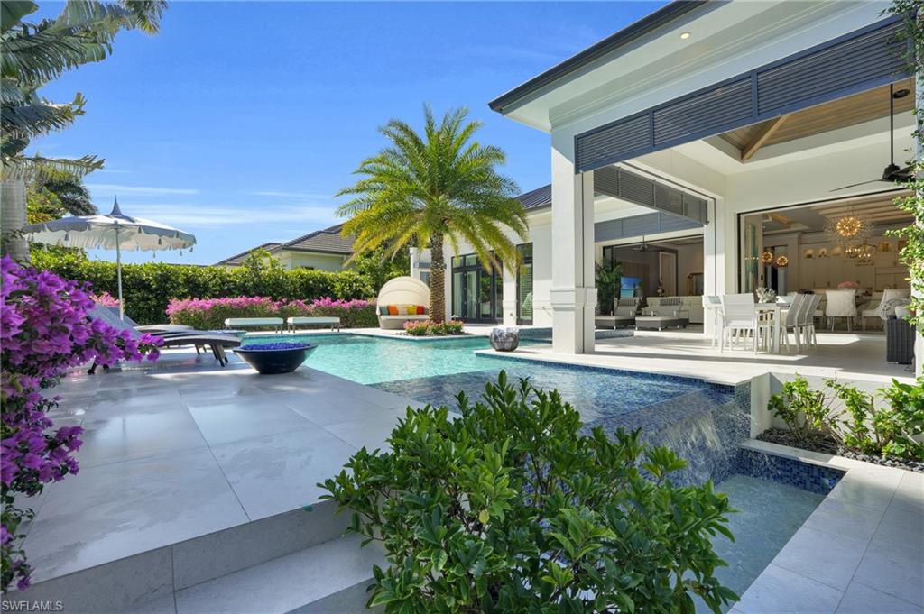 3110 Leeward Lane Naples, FL 34103 - Photo 49 of 50 a view of a swimming pool with a patio