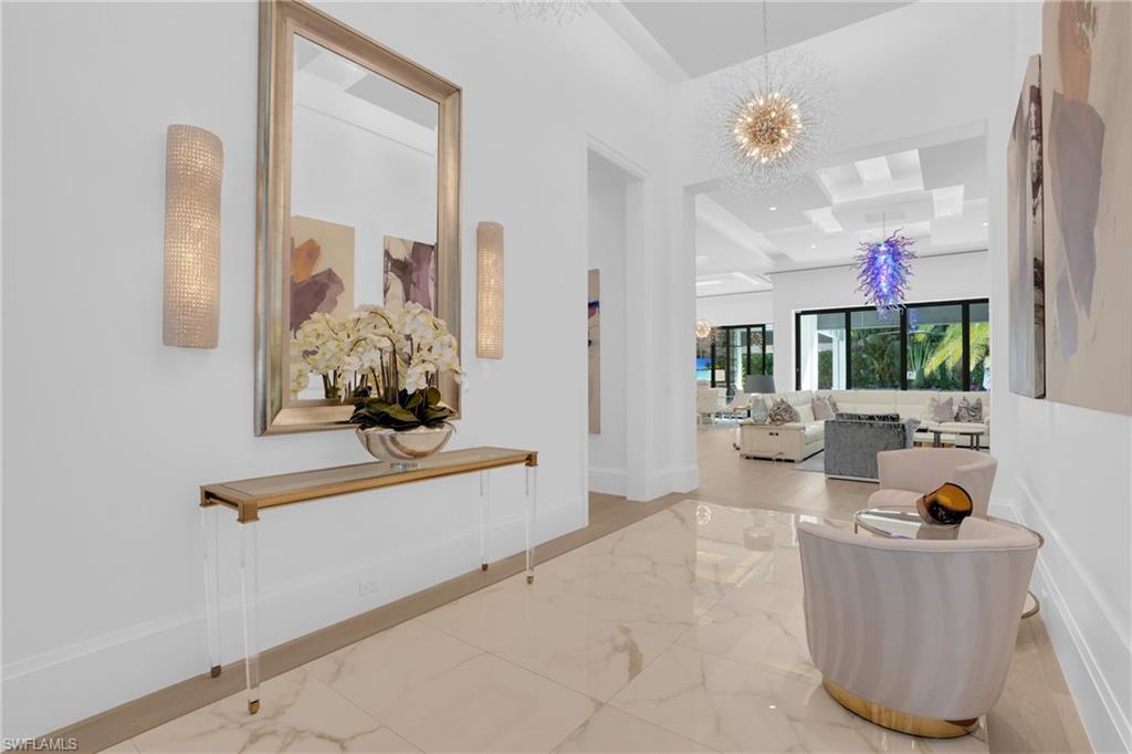 3110 Leeward Lane Naples, FL 34103 - Photo 7 of 50 a living room with furniture and a chandelier