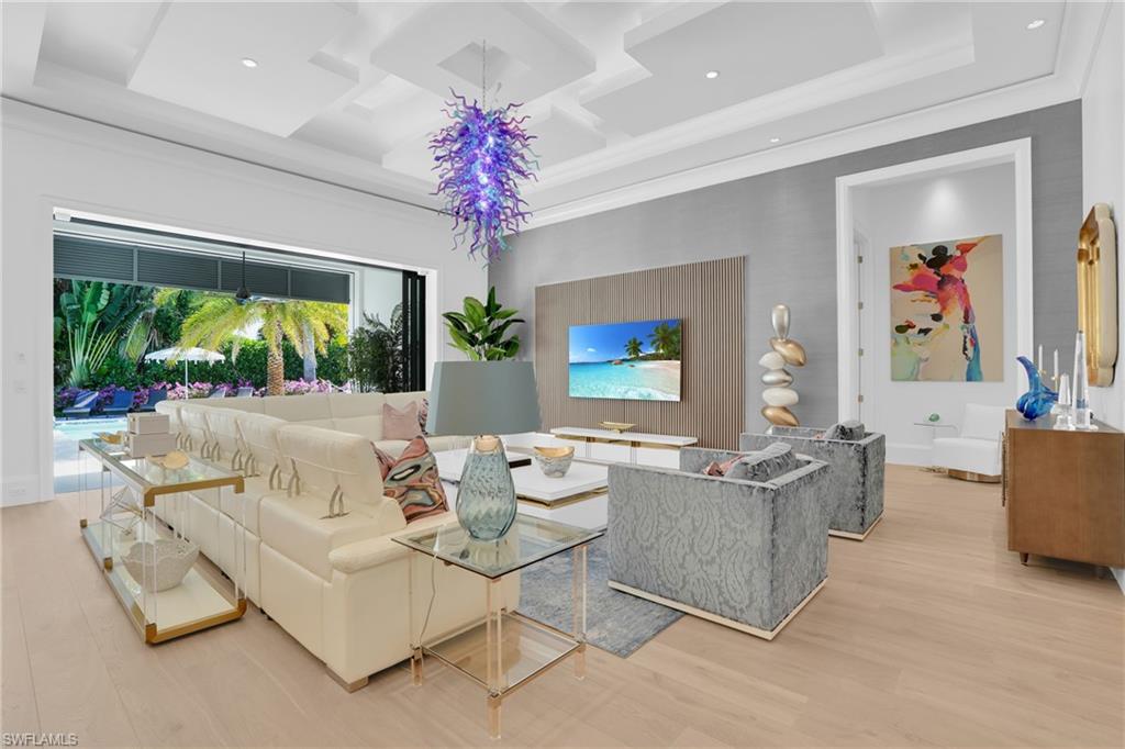 3110 Leeward Lane Naples, FL 34103 - Photo 8 of 50 a living room with furniture and a large window