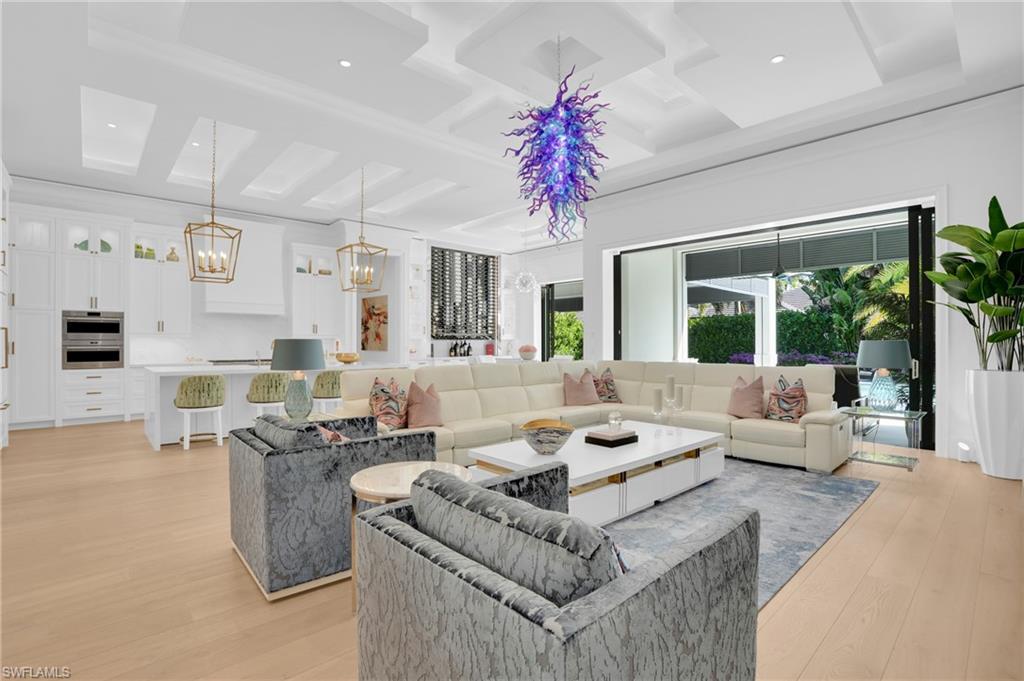 3110 Leeward Lane Naples, FL 34103 - Photo 10 of 50 a living room with furniture and a large window