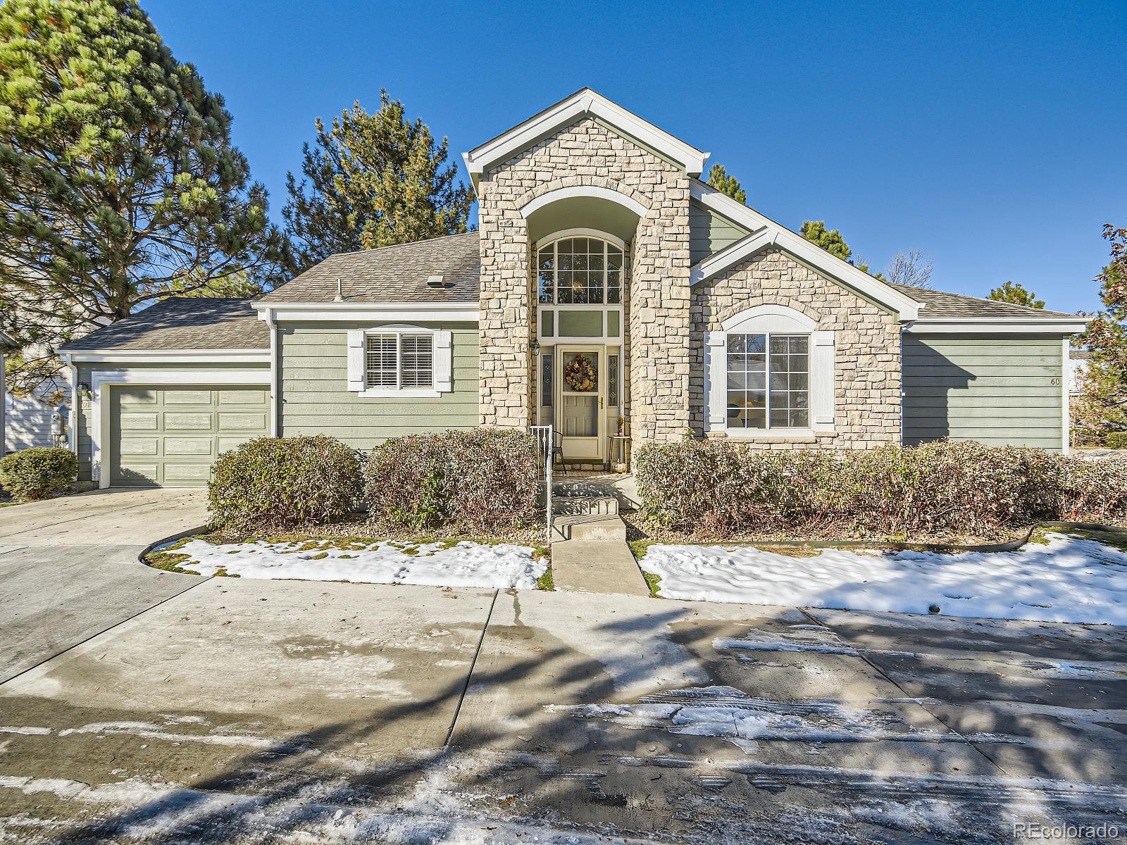 7400 West Grant Ranch Boulevard, Unit 60 Denver, CO 80123 - Photo 1 of 36 a front view of a house with a yard
