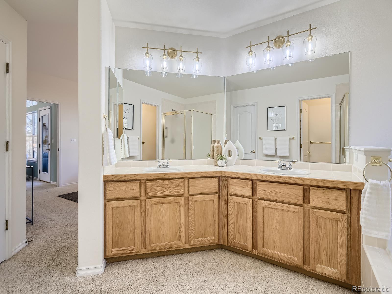 7400 West Grant Ranch Boulevard, Unit 60 Denver, CO 80123 - Photo 15 of 36 a spacious bathroom with a double vanity sink and a mirror