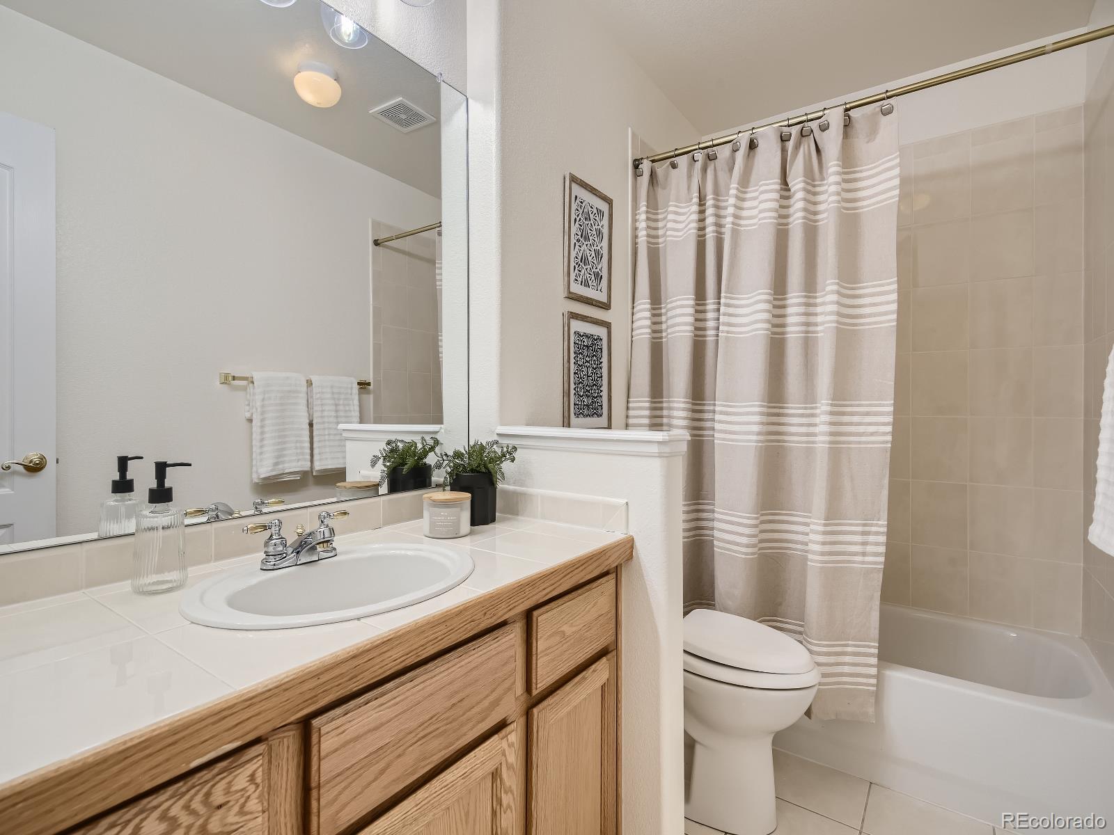 7400 West Grant Ranch Boulevard, Unit 60 Denver, CO 80123 - Photo 18 of 36 a bathroom with a sink a toilet and shower