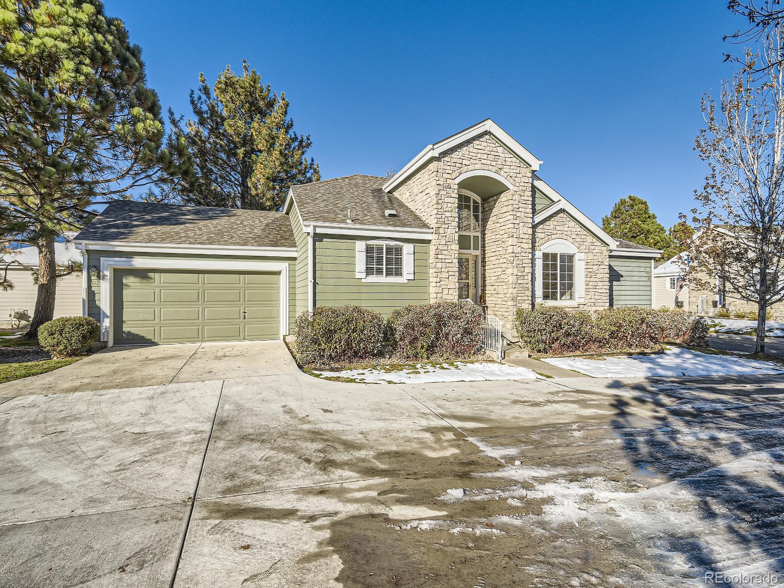 7400 West Grant Ranch Boulevard, Unit 60 Denver, CO 80123 - Photo 2 of 36 a front view of a house with a yard