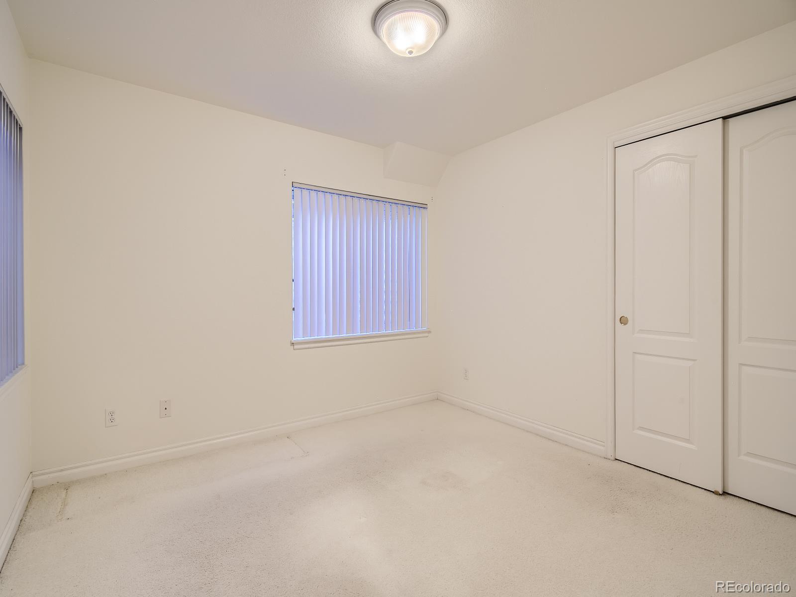 7400 West Grant Ranch Boulevard, Unit 60 Denver, CO 80123 - Photo 25 of 36 an empty room with windows