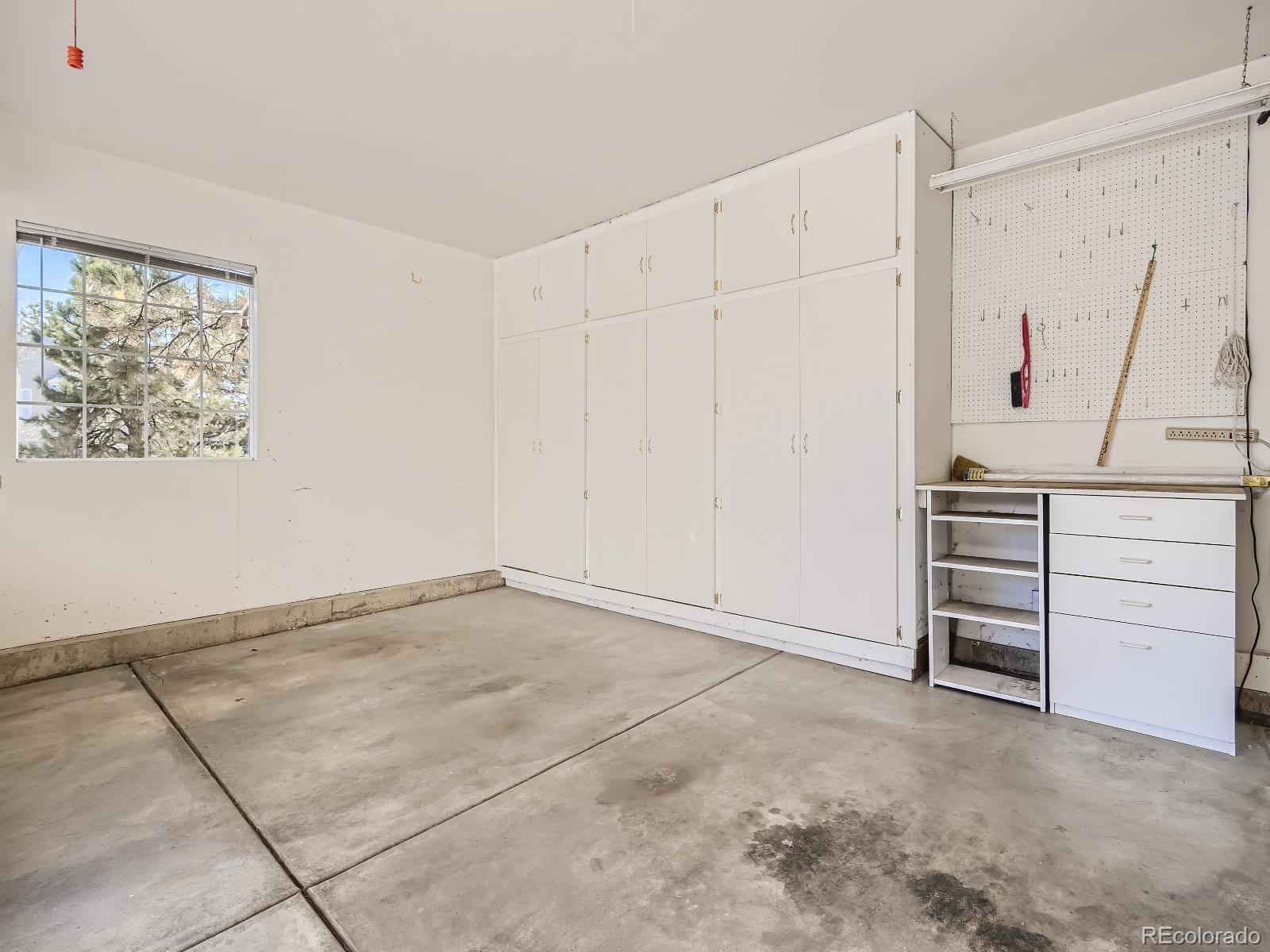 7400 West Grant Ranch Boulevard, Unit 60 Denver, CO 80123 - Photo 26 of 36 a view of an empty room with cabinet and a window