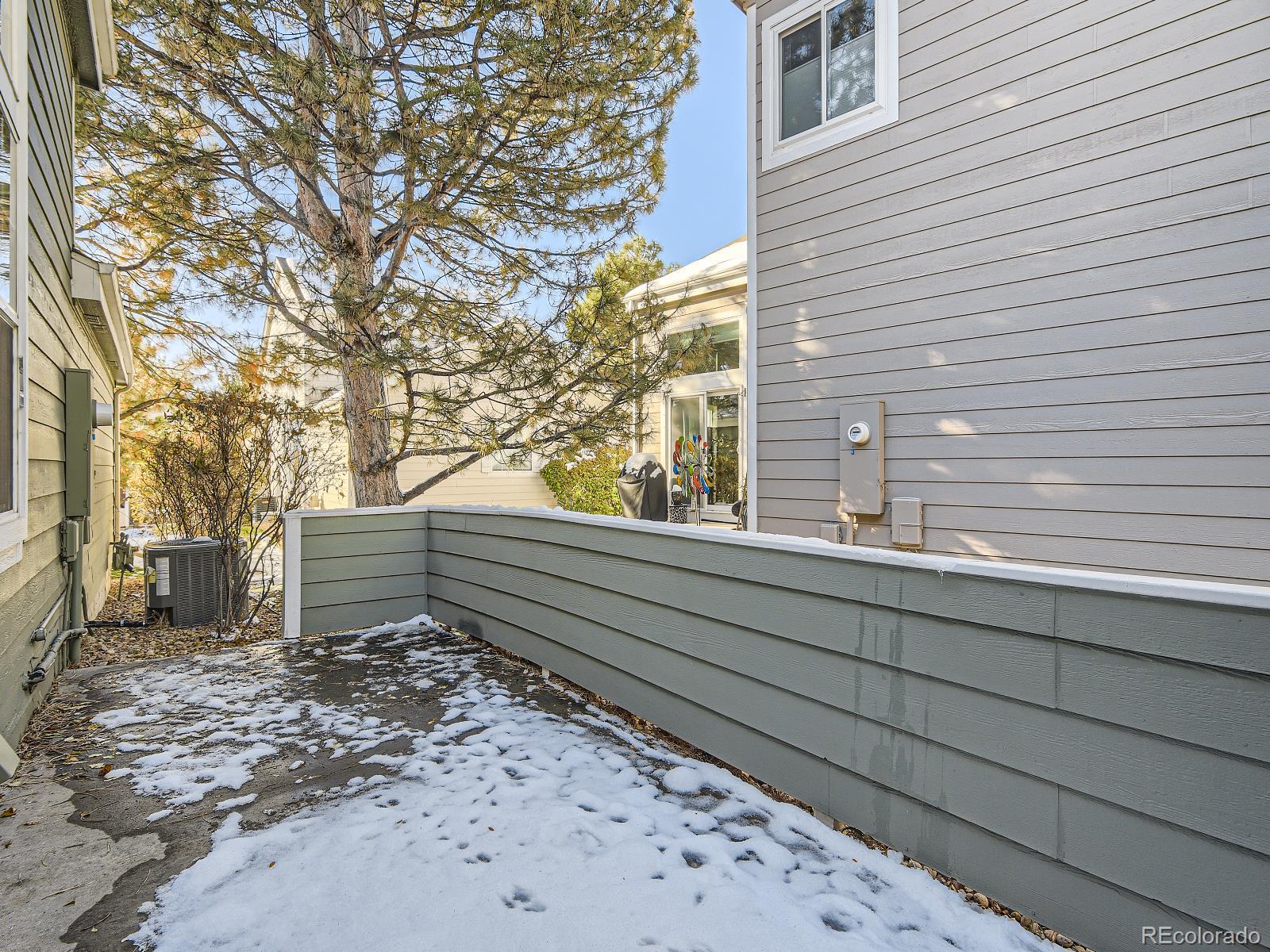 7400 West Grant Ranch Boulevard, Unit 60 Denver, CO 80123 - Photo 27 of 36 a bench sitting in front of a house