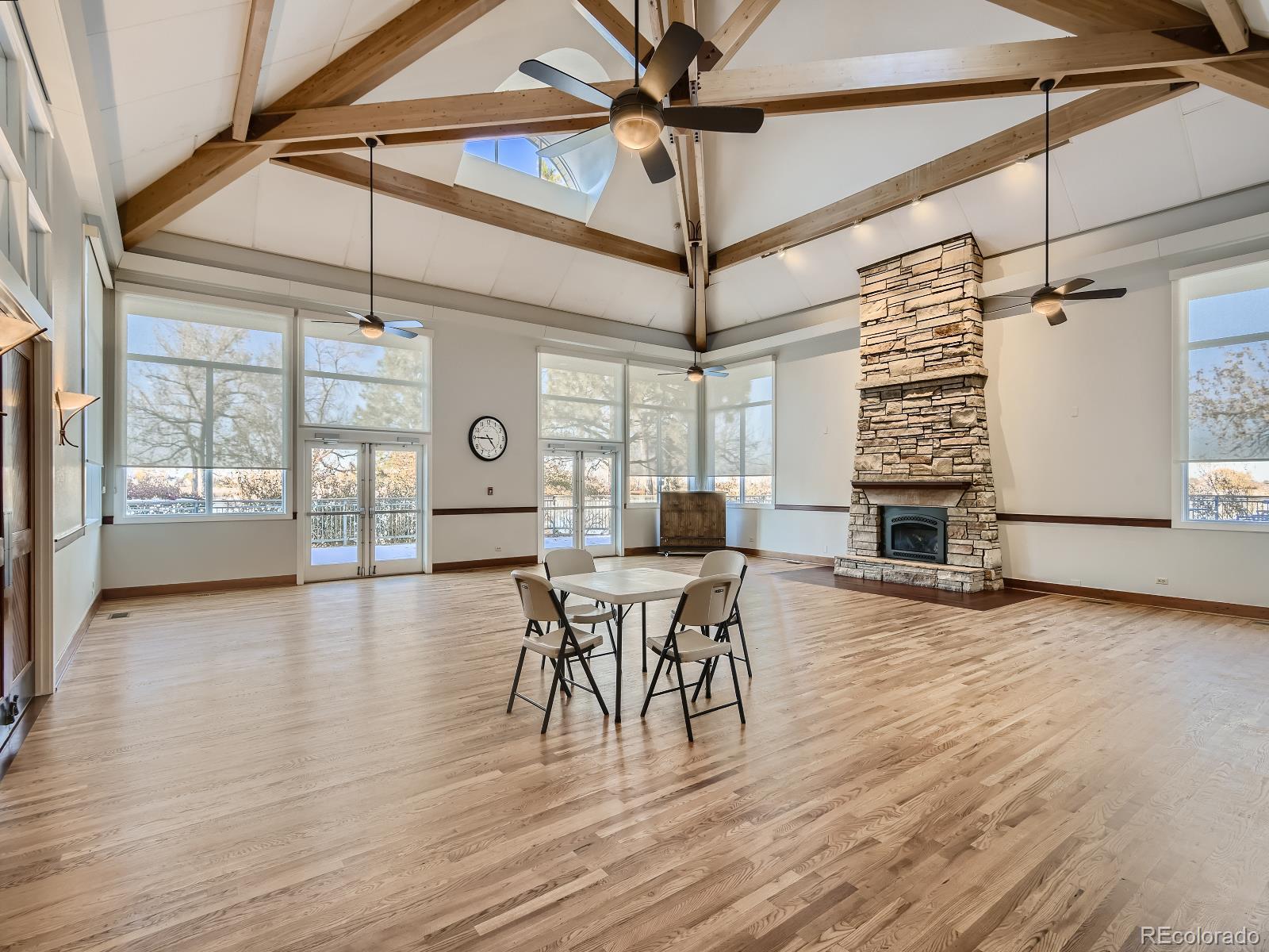 7400 West Grant Ranch Boulevard, Unit 60 Denver, CO 80123 - Photo 29 of 36 a dining room with wooden floor a chandelier a glass table and chairs