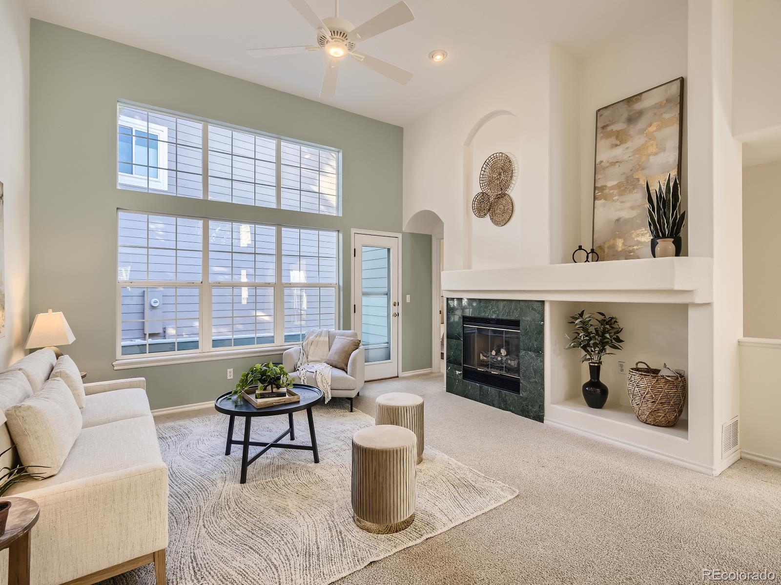 7400 West Grant Ranch Boulevard, Unit 60 Denver, CO 80123 - Photo 5 of 36 a living room with furniture and a fireplace