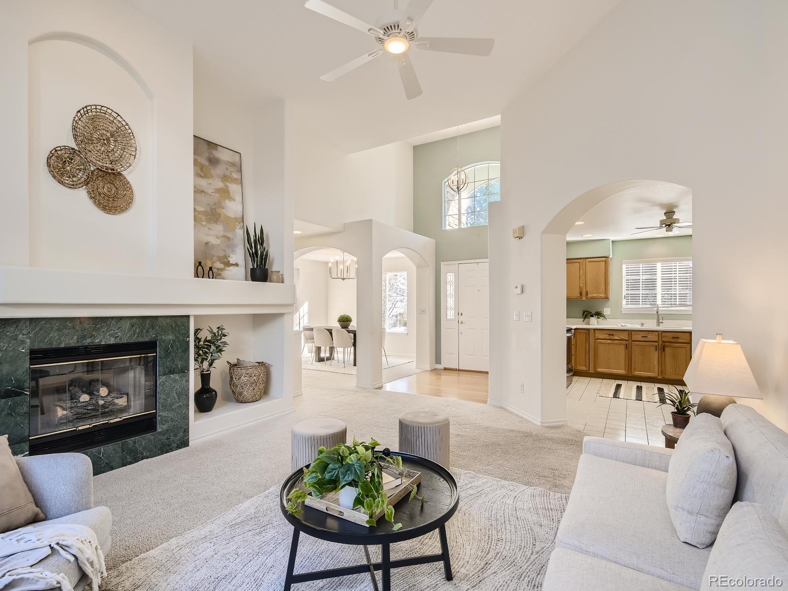 7400 West Grant Ranch Boulevard, Unit 60 Denver, CO 80123 - Photo 6 of 36 a living room with furniture and a fireplace
