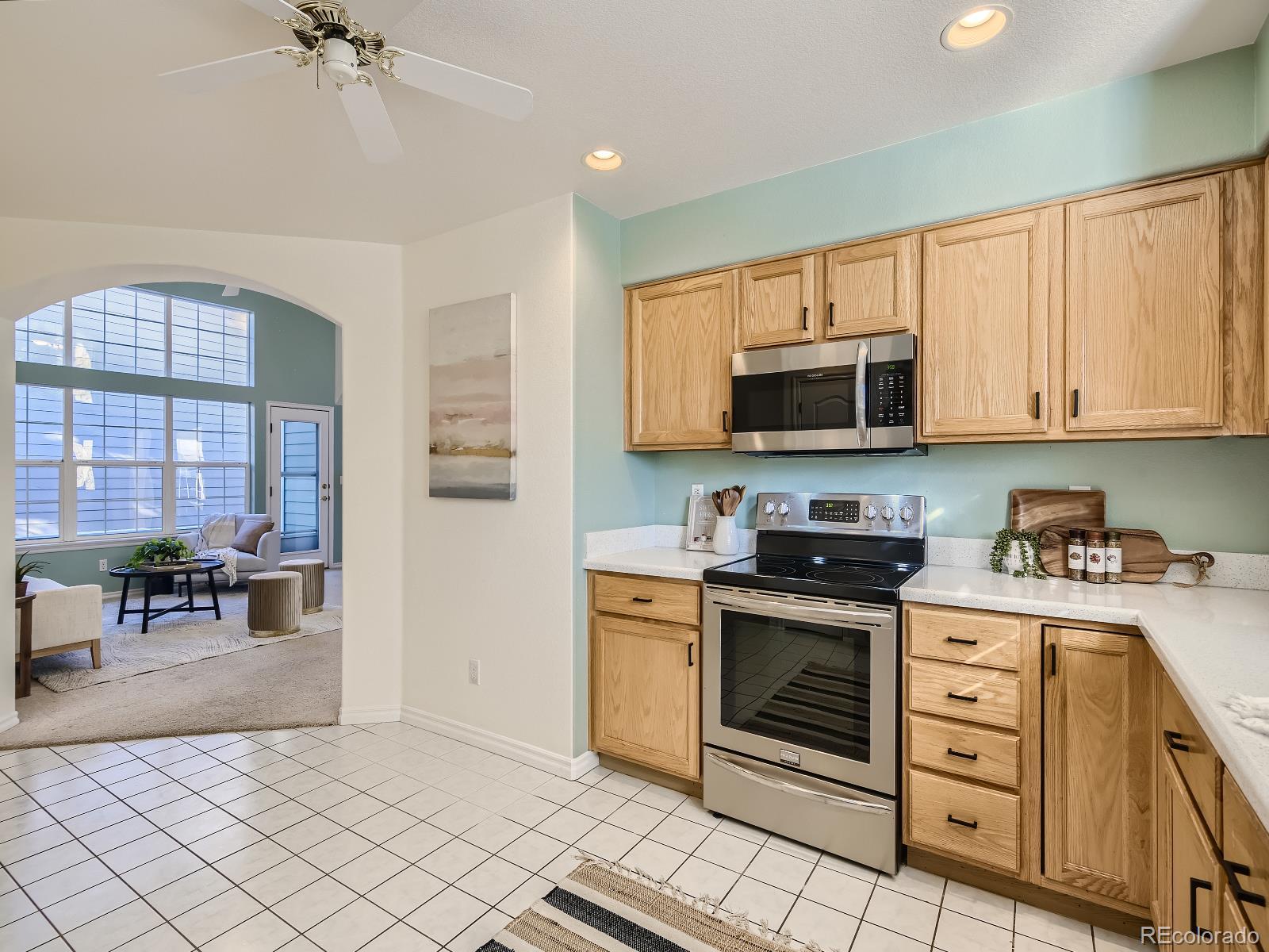 7400 West Grant Ranch Boulevard, Unit 60 Denver, CO 80123 - Photo 9 of 36 a kitchen with stainless steel appliances granite countertop a stove and a sink
