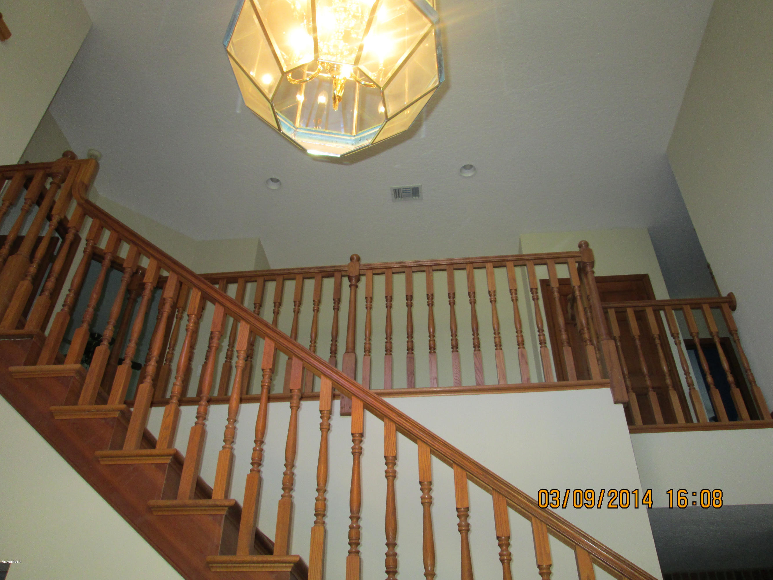 4254 Turtle Mound Road Melbourne, FL 32934 - Photo 5 of 12 stairway and chandelier