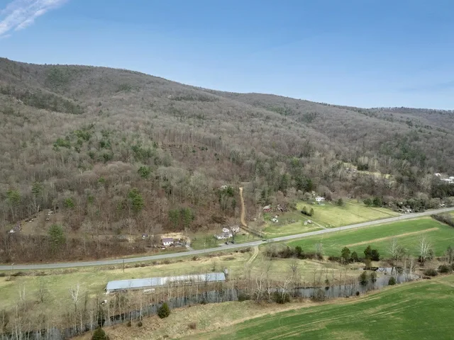 a view of a field with mountains in the background