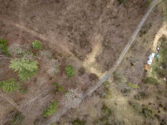 a view of backyard with wooden fence