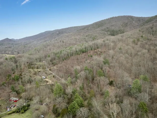 a view of a dry ground with mountains in the background
