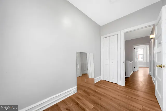 a view of a room with wooden floor