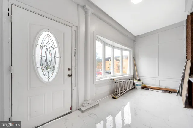 a view of an entryway with wooden floor and mirror