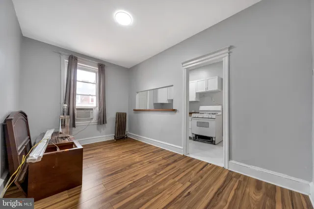 a room with wooden floor and windows