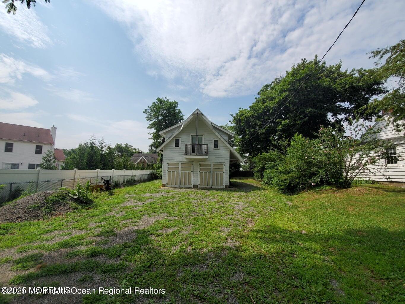 92 Compton Street Belford, NJ 07718 - Photo 2 of 27 a view of a house with a big yard and large trees