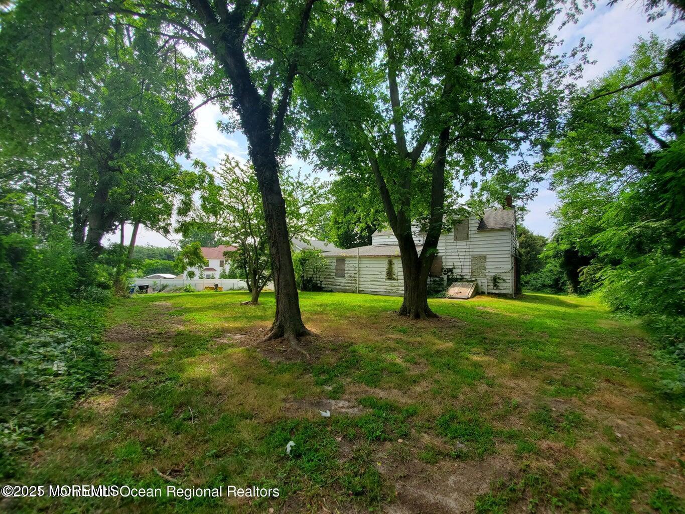 92 Compton Street Belford, NJ 07718 - Photo 5 of 27 a view of an trees in a yard