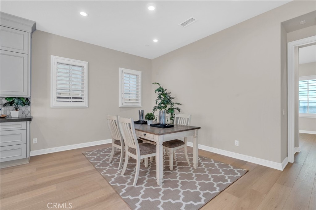 112 Clear Falls Irvine, CA 92602 - Photo 15 of 62 a view of a dining room with furniture and wooden floor