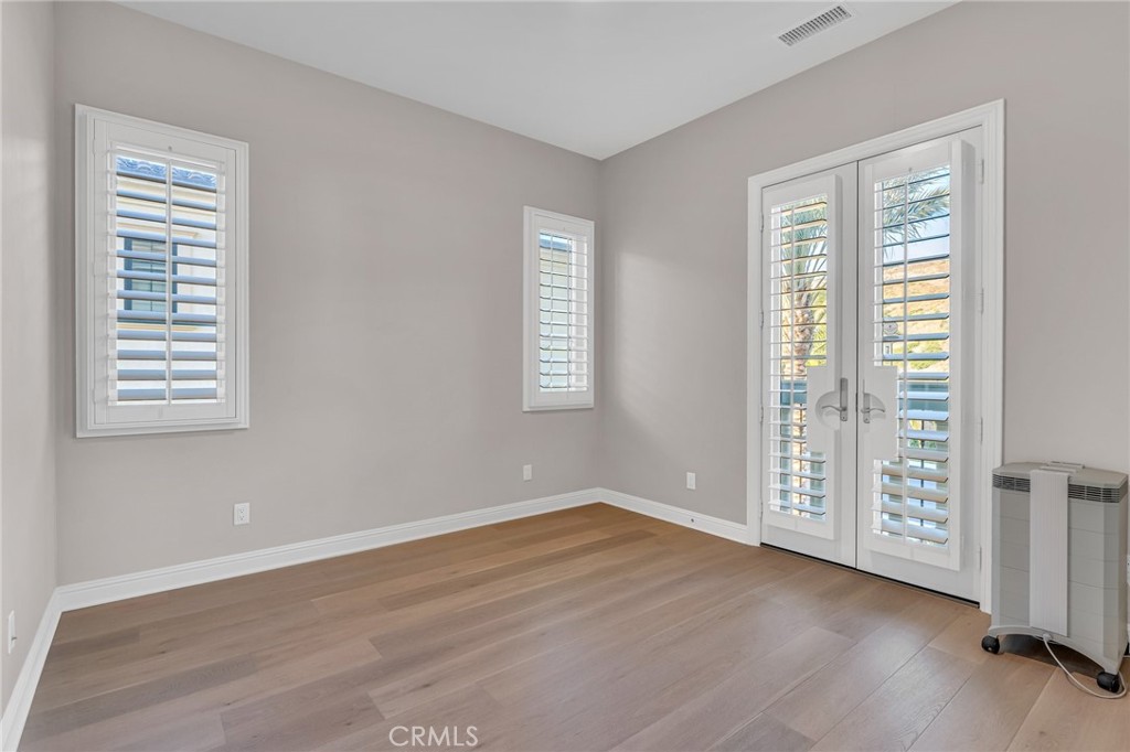 112 Clear Falls Irvine, CA 92602 - Photo 30 of 62 an empty room with wooden floor and windows