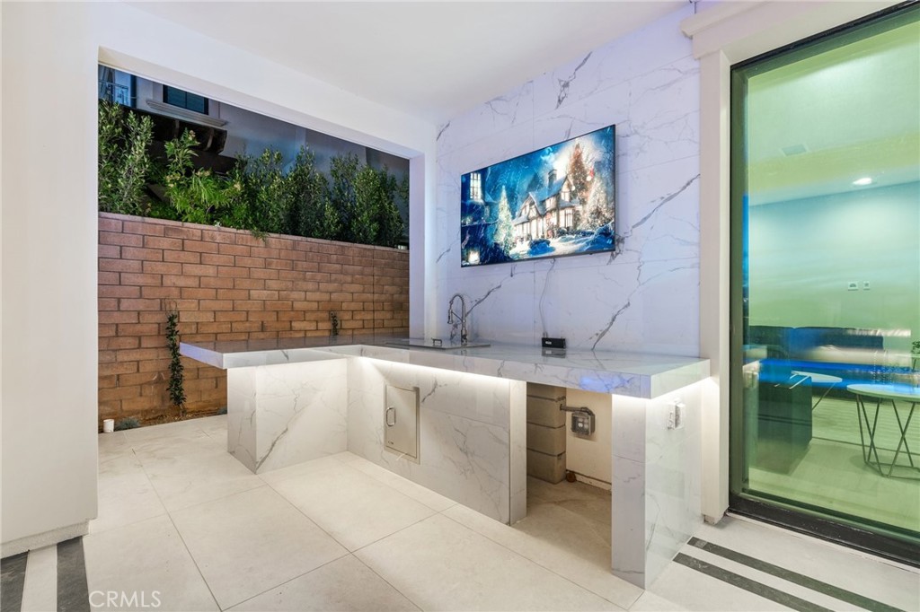 112 Clear Falls Irvine, CA 92602 - Photo 52 of 62 a living room with stainless steel appliances kitchen island granite countertop furniture and a flat screen tv