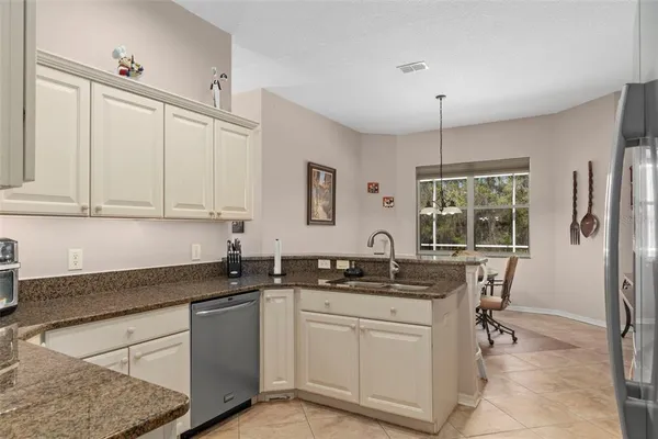 a bathroom with a granite countertop toilet sink and mirror