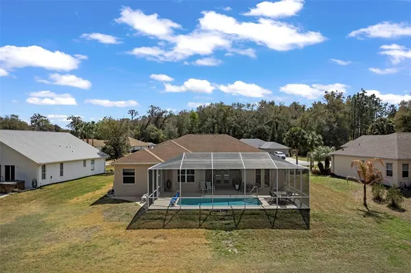 a view of a house with backyard and sitting area