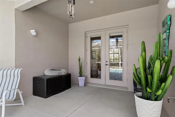 a bedroom with a bed chandelier and a window