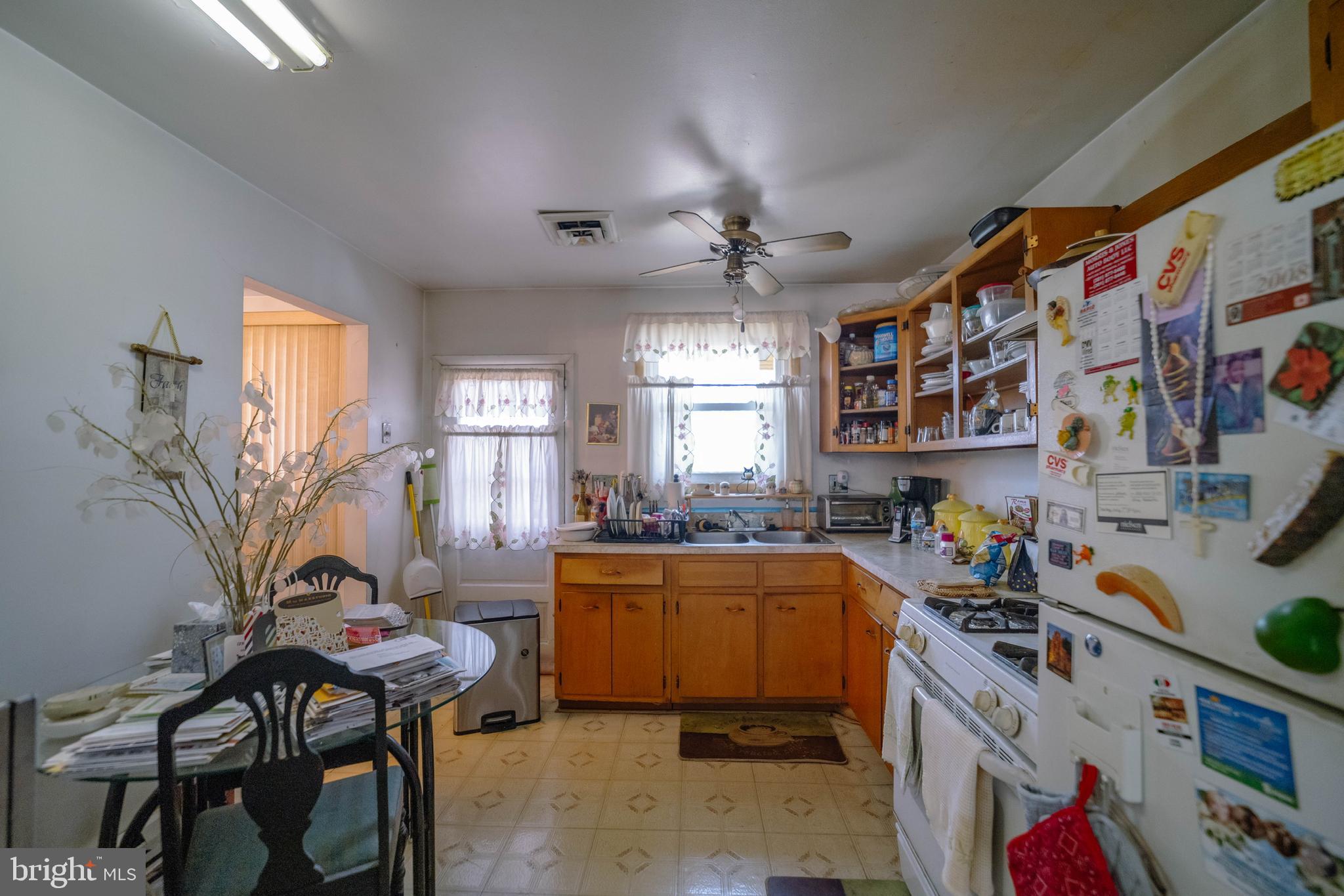 6900 Temple Hill Road Temple Hills, MD 20748 - Photo 23 of 43 a kitchen that has a lot of cabinets a sink and a stove in it