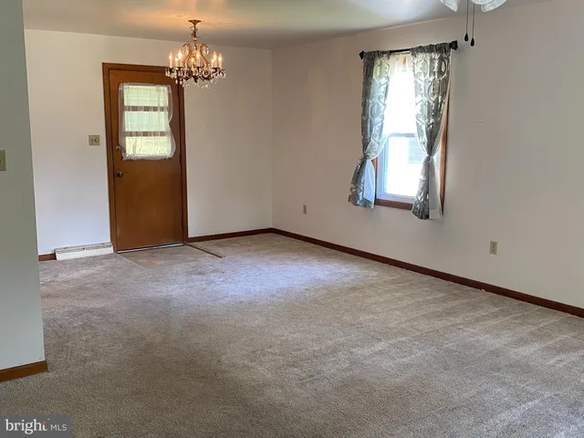 an empty room with windows and entrance