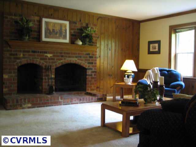 1001 Kingscross Road Midlothian, VA 23114 - Photo 2 of 10 Other - Cozy great room with new carpet, new paint and a wood burning fireplace.