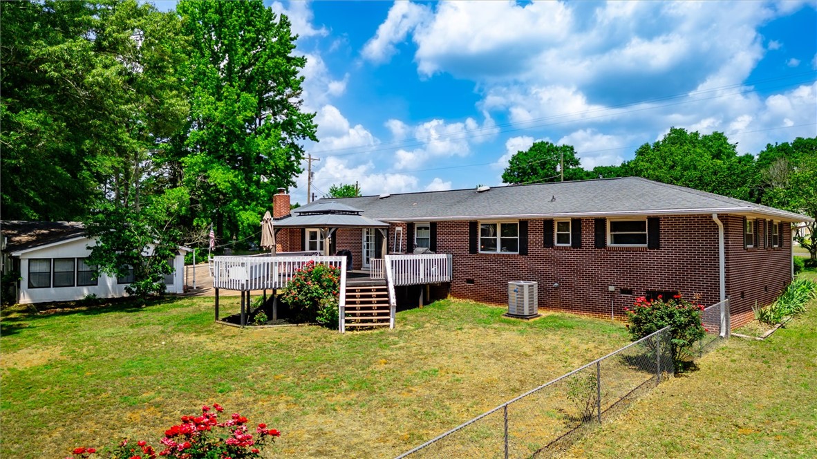 1815 Pearman Dairy Road Anderson, SC 29625 - Photo 22 of 35 A fenced backyard with a spacious deck offers delightful outdoor living and serene privacy.