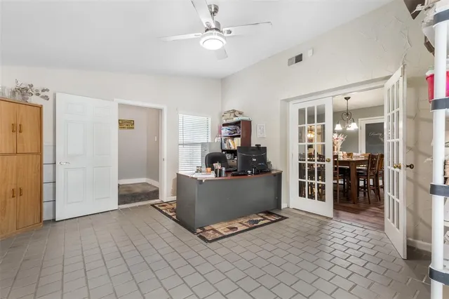a living room with furniture and a kitchen