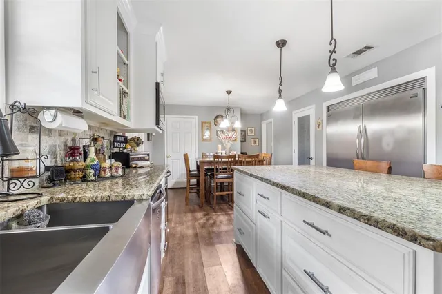 a kitchen with stainless steel appliances granite countertop sink stove and cabinets