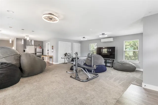 a living room with furniture a window and gym equipment