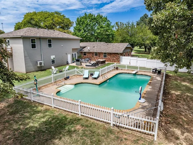 a view of a house with backyard and sitting area
