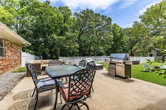 a backyard of a house with table and chairs