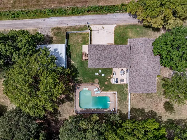 an aerial view of a house with outdoor space and lake view