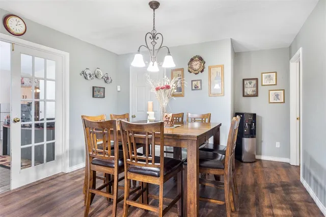 a view of a dining room with furniture wooden floor and chandelier