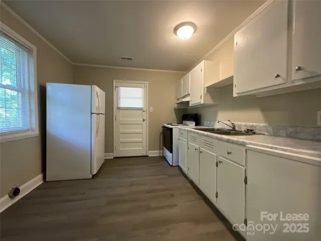 a kitchen with stainless steel appliances granite countertop a refrigerator sink and cabinets