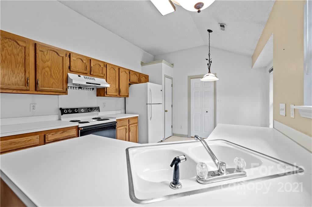 11232 Clayford Ridge Charlotte, NC 28215 - Photo 5 of 22 a kitchen with stainless steel appliances granite countertop a sink refrigerator and cabinets