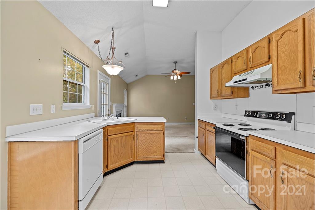 11232 Clayford Ridge Charlotte, NC 28215 - Photo 8 of 22 a kitchen with stainless steel appliances granite countertop a stove and a sink