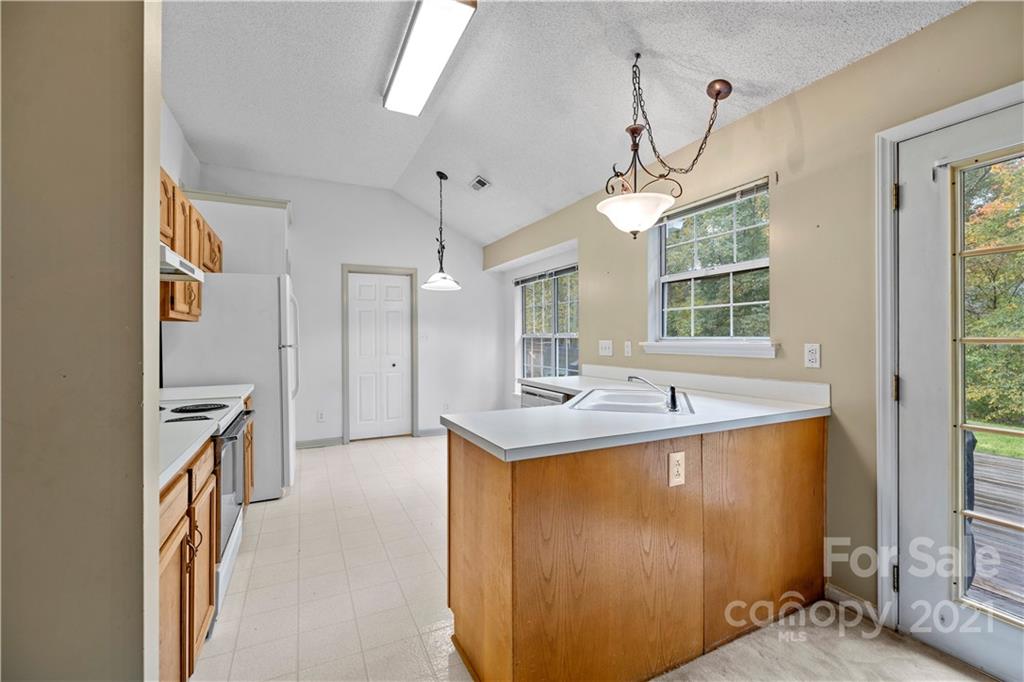 11232 Clayford Ridge Charlotte, NC 28215 - Photo 9 of 22 a kitchen with stainless steel appliances granite countertop a sink a refrigerator and a granite counter tops