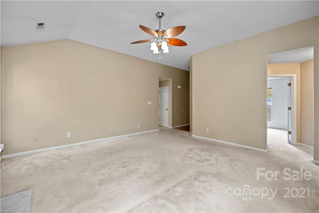 11232 Clayford Ridge Charlotte, NC 28215 - Photo 10 of 22 an empty room with window and ceiling fan