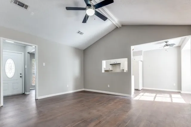 wooden floor in an empty room and a window