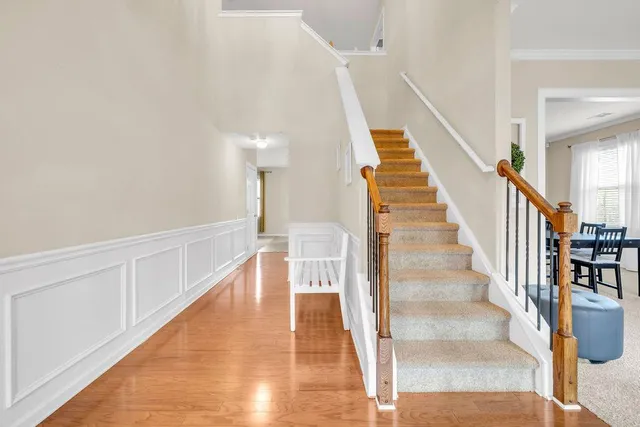 a view of entryway and hall with wooden floor