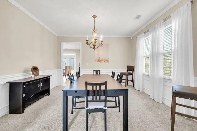 a view of a dining room with furniture and window